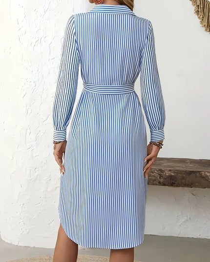 Woman wearing a blue and white striped dress against a white background