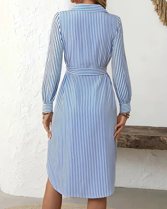 Woman wearing a blue and white striped dress against a white background