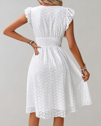 Woman wearing broderie v-neck summer dress