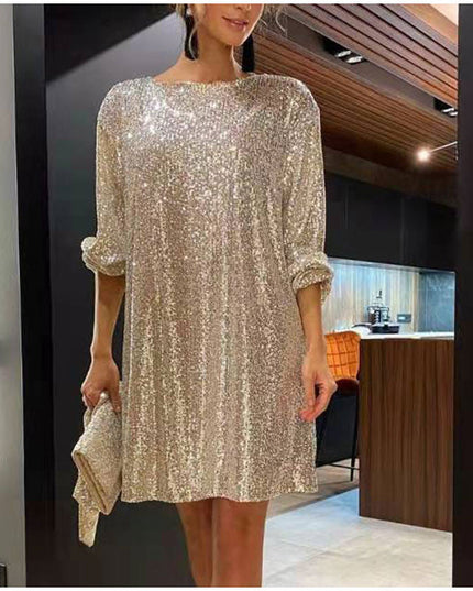Woman wearing sparkling sequin mini dress with waist tie detail