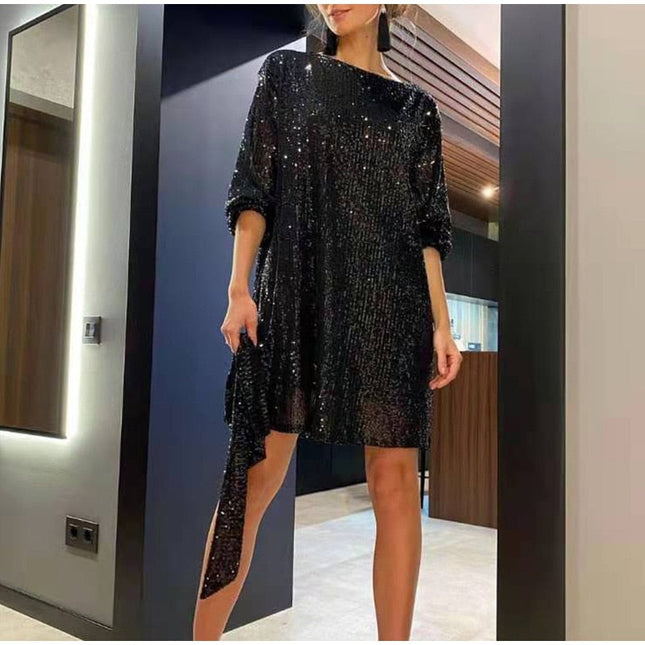 Woman wearing sparkling sequin mini dress with waist tie detail