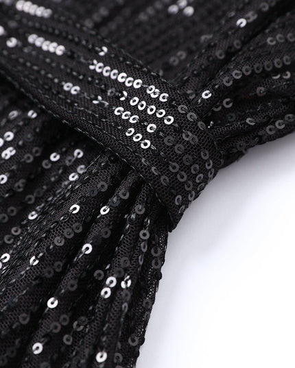 Woman wearing sparkling sequin mini dress with waist tie detail