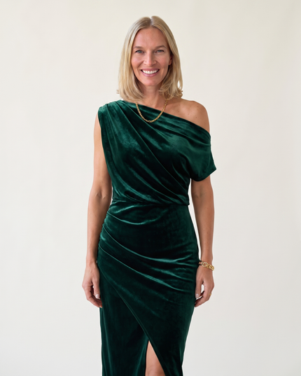 Woman wearing one-shoulder midi dress with luxe velvet finish