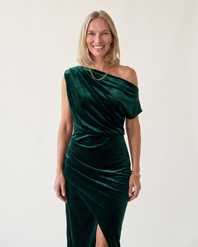 Woman wearing one-shoulder midi dress with luxe velvet finish