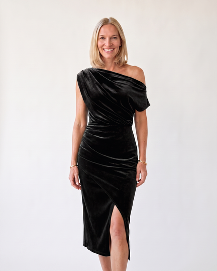 Woman wearing one-shoulder midi dress with luxe velvet finish