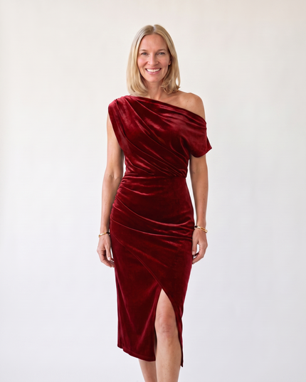 Woman wearing one-shoulder midi dress with luxe velvet finish