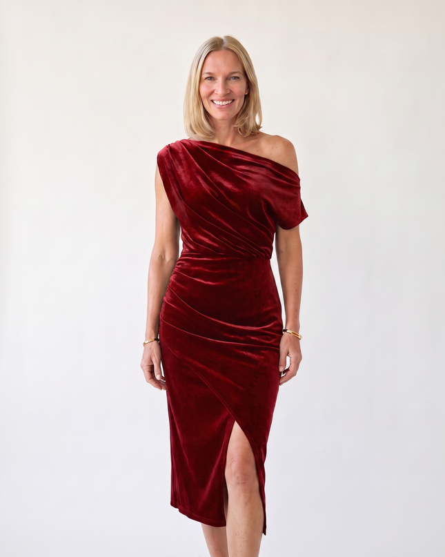 Woman wearing one-shoulder midi dress with luxe velvet finish