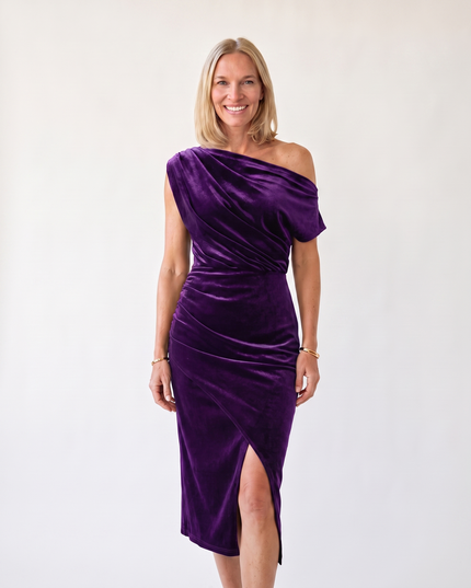 Woman wearing one-shoulder midi dress with luxe velvet finish