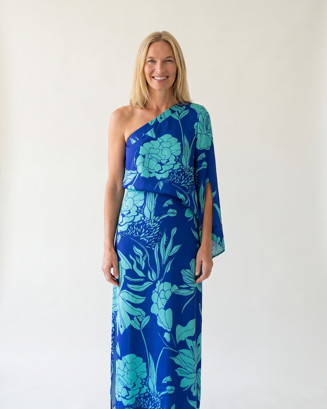 Woman wearing one-shoulder floral maxi dress with flowing silhouette