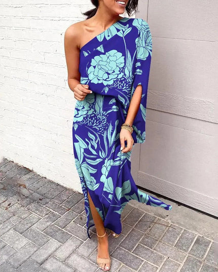 Woman wearing one-shoulder floral maxi dress with flowing silhouette