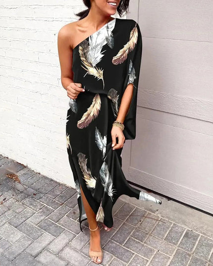 Woman wearing one-shoulder floral maxi dress with flowing silhouette