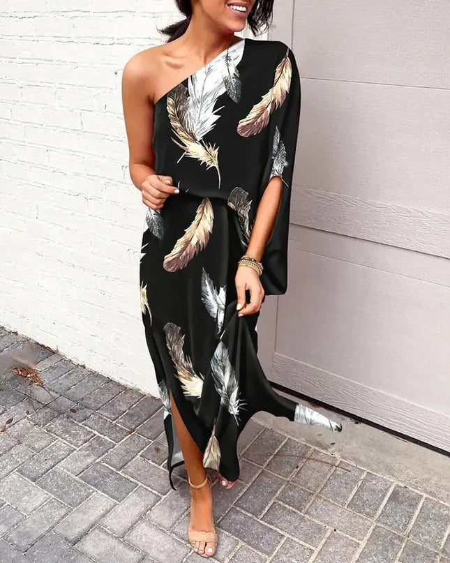 Woman wearing one-shoulder floral maxi dress with flowing silhouette