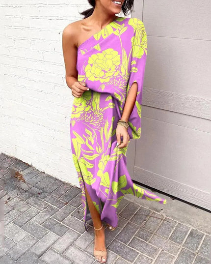 Woman wearing one-shoulder floral maxi dress with flowing silhouette