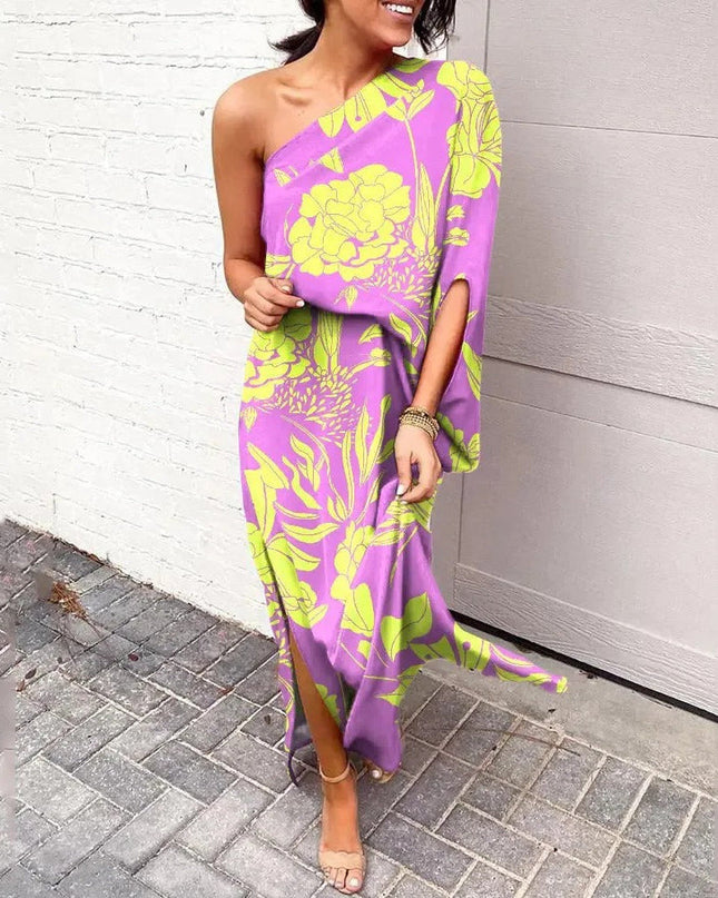 Woman wearing one-shoulder floral maxi dress with flowing silhouette