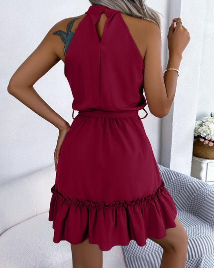 Woman wearing halter neck ruffle mini dress