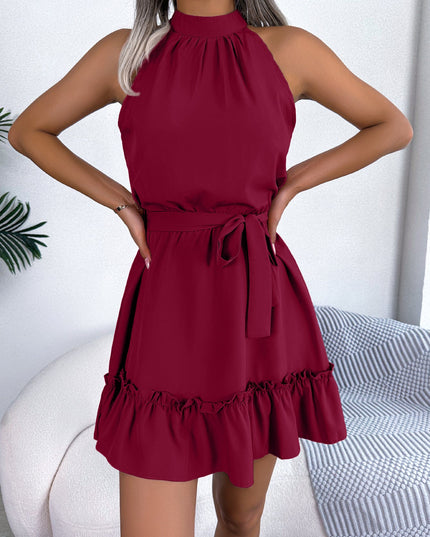 Woman wearing halter neck ruffle mini dress