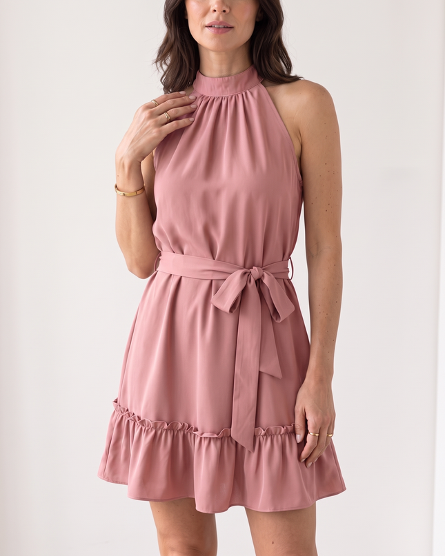 Woman wearing halter neck ruffle mini dress