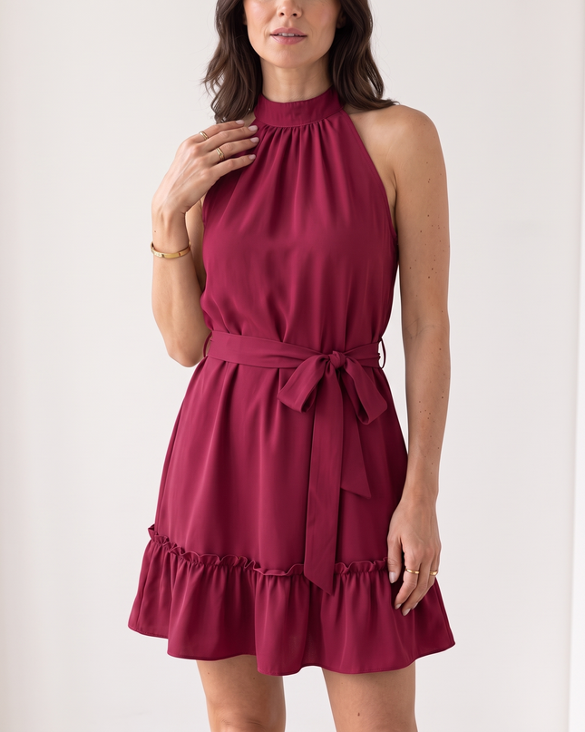 Woman wearing halter neck ruffle mini dress