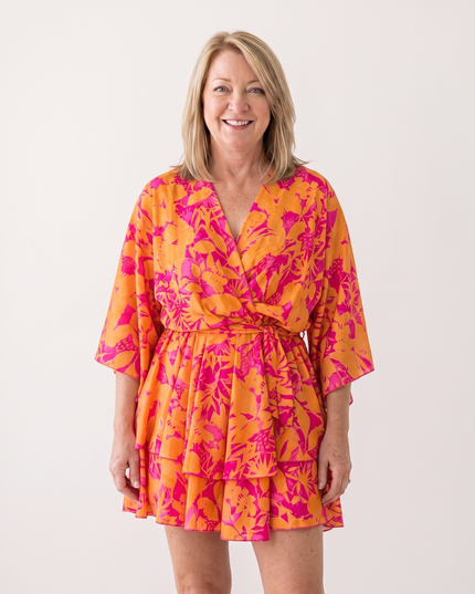 Woman wearing twist-front floral mini dress with layered ruffles