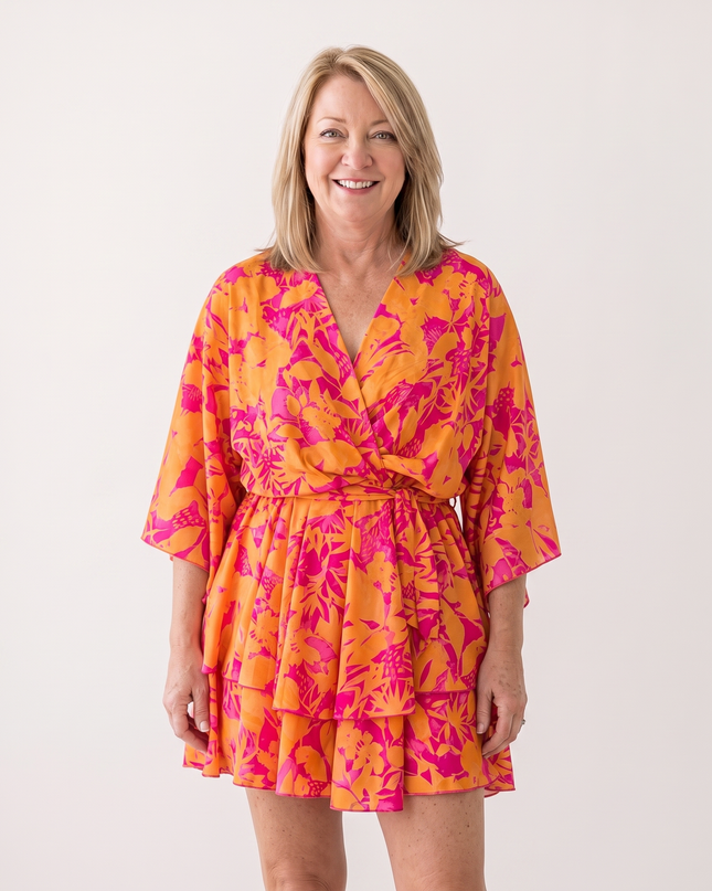Woman wearing twist-front floral mini dress with layered ruffles