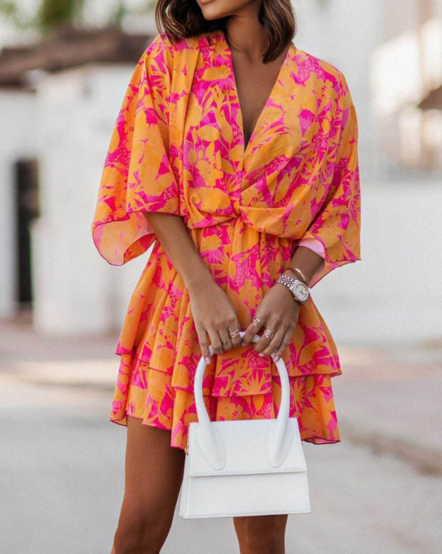 Woman wearing twist-front floral mini dress with layered ruffles