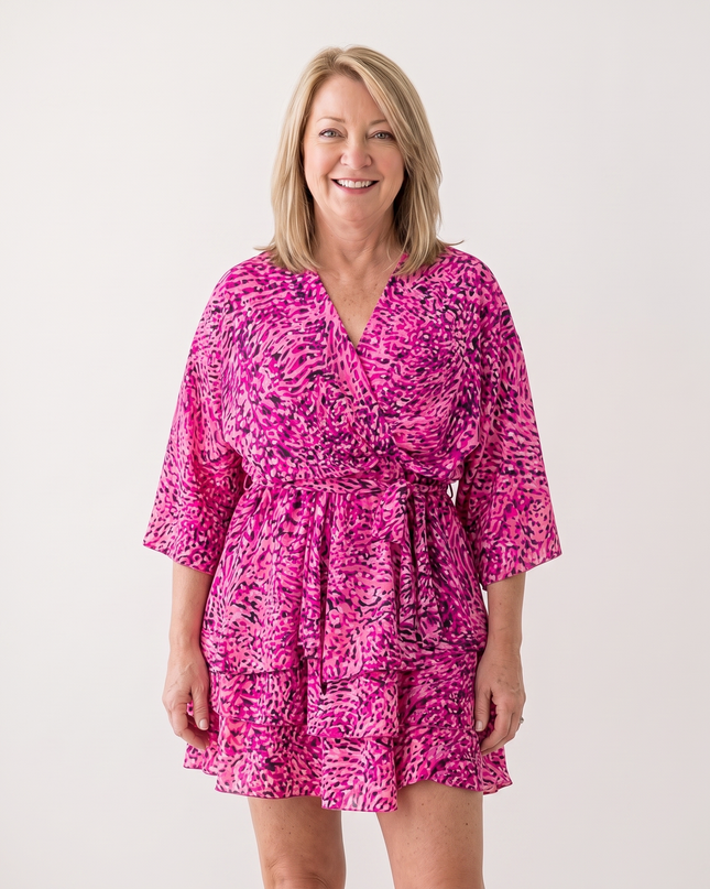 Woman wearing twist-front floral mini dress with layered ruffles