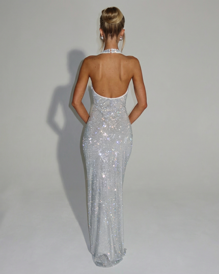 Woman wearing sequin halter maxi dress